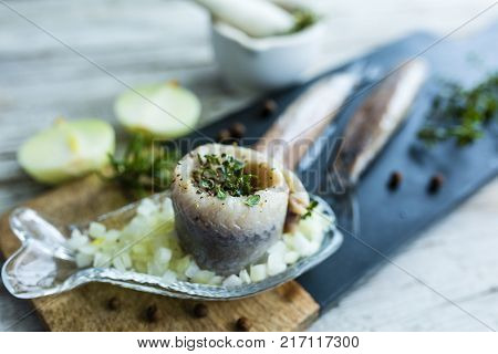 Delicious wrapped herring with fresh herbs and onions.