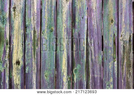 Abstract background of old worn wooden boards of different colors close up