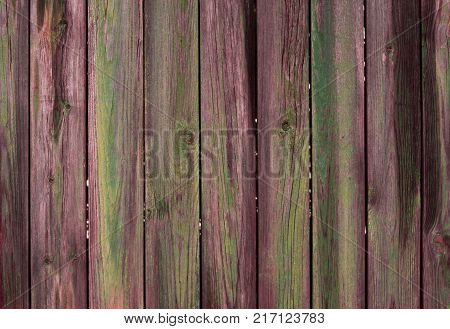 Abstract background of old worn wooden boards of different colors close up