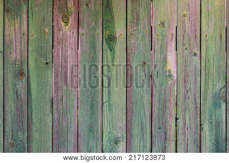Abstract background of old worn wooden boards of different colors close up