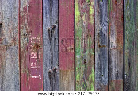 Abstract background of old worn wooden boards of different colors close up