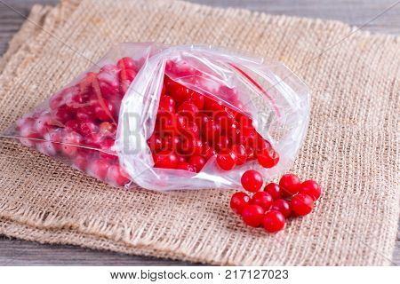 Frozen berries of a viburnum in a package on a table