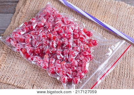Frozen berries of viburnum in a sealed bag on a table