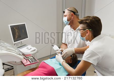 Process Of Preparing And Installing Dental Ceramic Crown. Professional Dentist And Assistant, Lookin