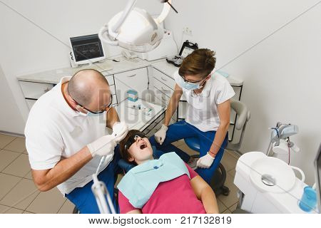 Process Of Preparing And Installing Dental Ceramic Crown. Professional Dentist And Assistant, Lookin