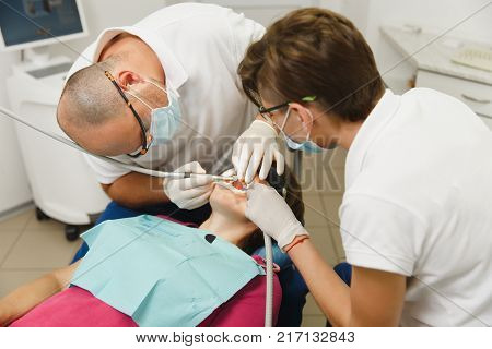 Process Of Preparing And Installing Dental Ceramic Crown. Professional Dentist And Assistant, Lookin