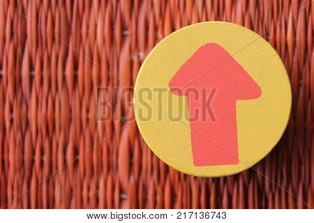 Traditional thai style nature background of brown handicraft weave texture wicker surface for furniture material with red arrow in yellow circle