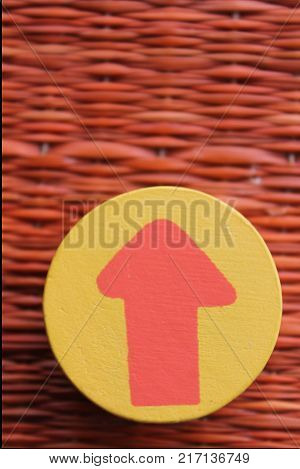 Traditional thai style nature background of brown handicraft weave texture wicker surface for furniture material with red arrow in yellow circle