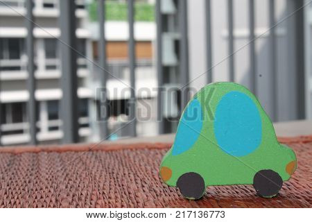 Traditional thai style nature background of brown handicraft weave texture wicker surface for furniture material with green toy car on it