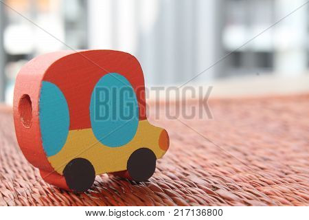 Traditional thai style nature background of brown handicraft weave texture wicker surface for furniture material with red toy car on it