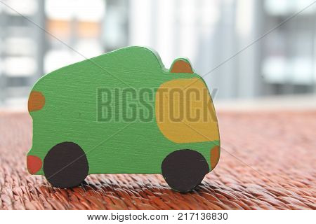 Traditional thai style nature background of brown handicraft weave texture wicker surface for furniture material with green toy car on it