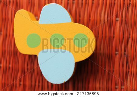 Traditional thai style nature background of brown handicraft weave texture wicker surface for furniture material with yellow toy plane on it