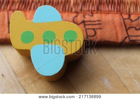 Traditional thai style nature background of brown handicraft weave texture wicker surface for furniture material with yellow toy plane on it