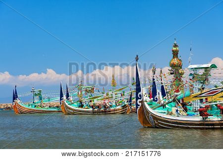 Jembrana Bali Island Indonesia - September 20 2015: Traditional wooden fishing boats mooring in old fishers port on Bali island near Perancak village. Popular place to visit in Jembrana regency.