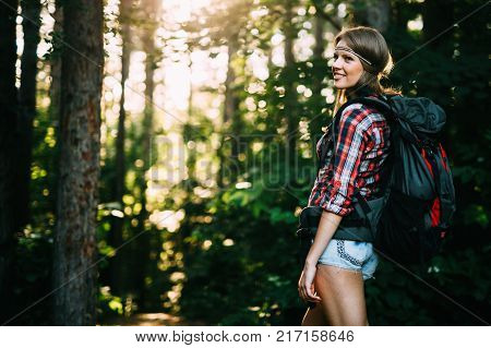 Female backpacker set out on forest hike advanture
