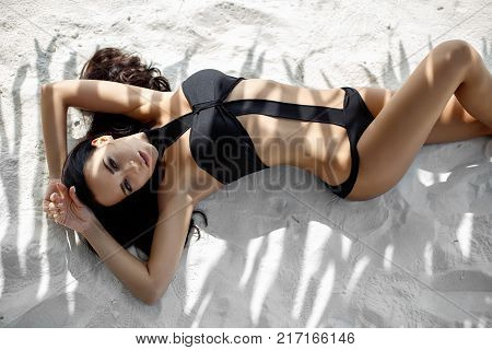Beautiful young girl in a sexy bikini on the beach