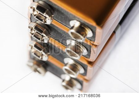 Stack of nine volt batteries on white background