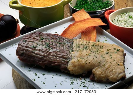 Roasted meat with rice, farofa and kale