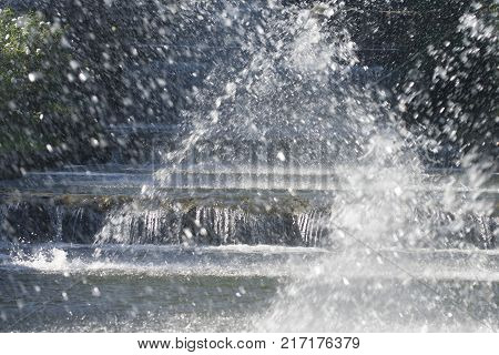 plays of spashes of water from the spouts of a seies of fountain
