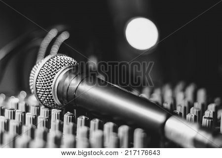 the microphone rests on an audio mixer