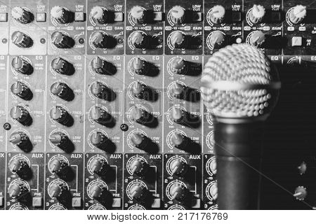 the microphone rests on an audio mixer