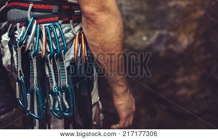 Man standing with climbing equipment outdoor rear view. Face is not visible