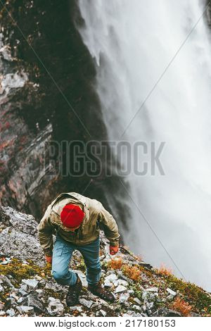 Man climbing in mountains waterfall on background outdoor Travel Lifestyle survival concept adventure vacations wild nature landscape