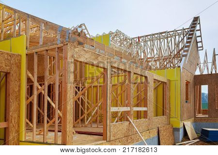 Installation of wooden beams at construction of frame house a new home under construction wooden frame house construction