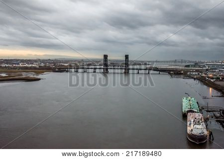JERSEY CITY NEW JERSEY - DECEMBER 5: An overcast scenic view of the Hackensack River with the Wittpenn Bridge in the distance on December 5 2017 in New Jersey.