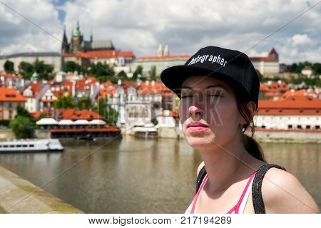 Dreaming woman with closed eyes at Charles bridge in Prague Czech republic