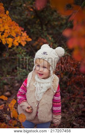 Cute Young Russian Baby Girl Stylish Dressed In Warm White Fur Handmade Jacket Blue Jeans Boots And 