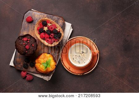 Muffins with berries and coffee. Top view with space for your text
