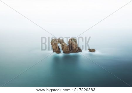 The door natural rock arch at the sea