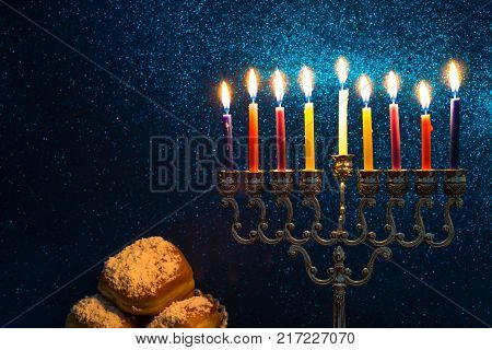 Image of the Hanukkah Jewish holiday with a menorah and burning candles
