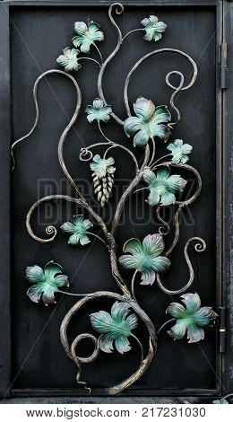 beautiful forged metal ornament on a black background close-up