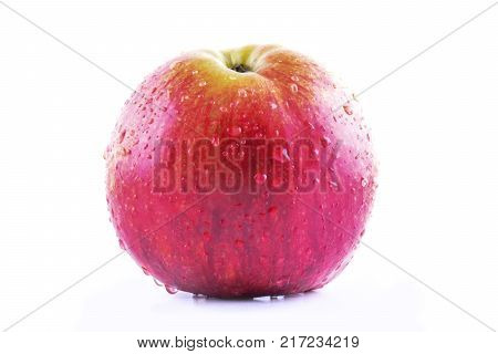 Red apple isolated on white background. Fresh raw organic fruit with water drops.