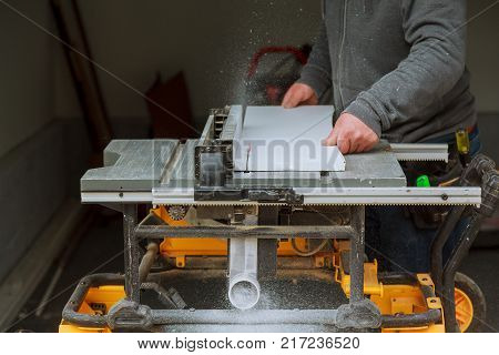 Detail of circular saw cutting piece of wood