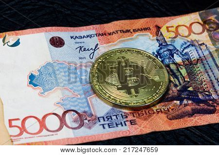 Five thousand Kazakhstan tenge and gold bitcoin.