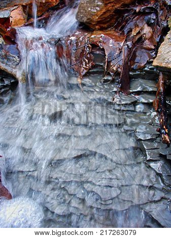 Small waterfall of melting snow at Kickapoo State Park in Illinois