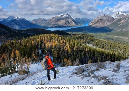 Man hiking in Canadian Rockies. Spray Lake in Spray Valley Provincial Park near Canmore and Banff. Alberta. Canada.