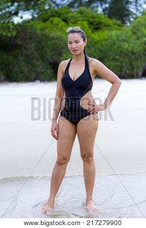 Woman black bikini show shape sexy on beach at Ban Krut Beach Prachuap Khirikhan Province Thailand