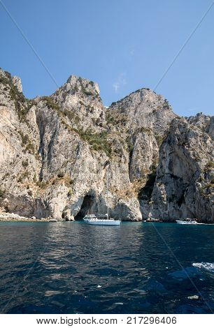 CAPRI ITALY - JUNE 13 2017: Boats with tourists near Grotta Bianca and Grotta Meravigliosa Capri Italy