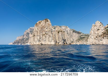 View from the boat on the cliff coast of Capri Island Italy