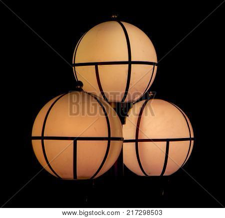 The street lamp in the form of bunches of different colors of round form.
