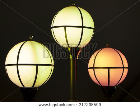 The street lamp in the form of bunches of different colors of round form.