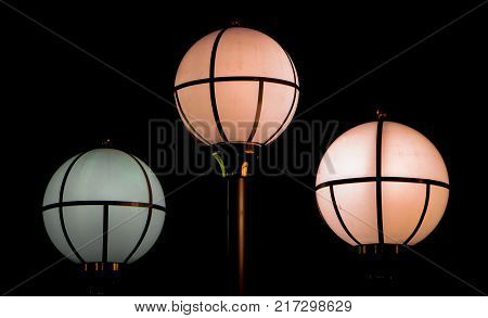 The street lamp in the form of bunches of different colors of round form.