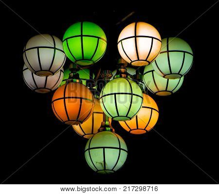 The street lamp in the form of bunches of different colors of round form.