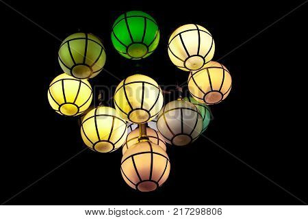 The street lamp in the form of bunches of different colors of round form.