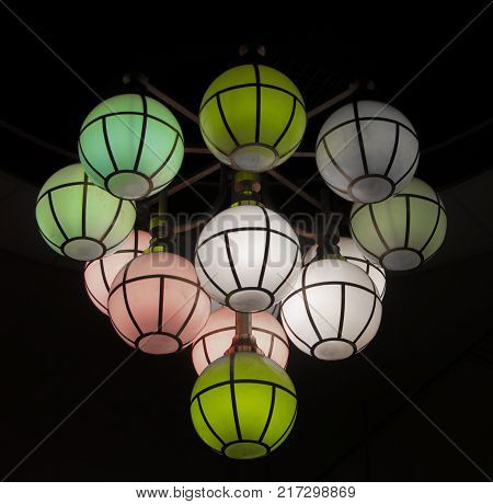 The street lamp in the form of bunches of different colors of round form.