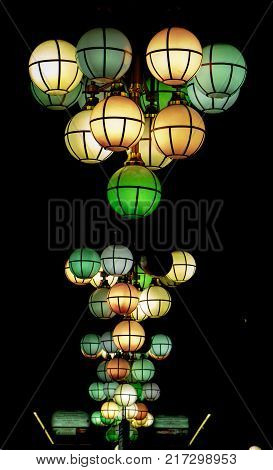 The street lamp in the form of bunches of different colors of round form.